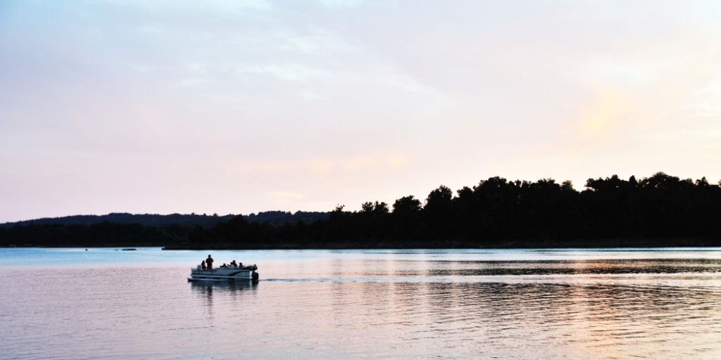 Boat on the water at dusk/dawn.