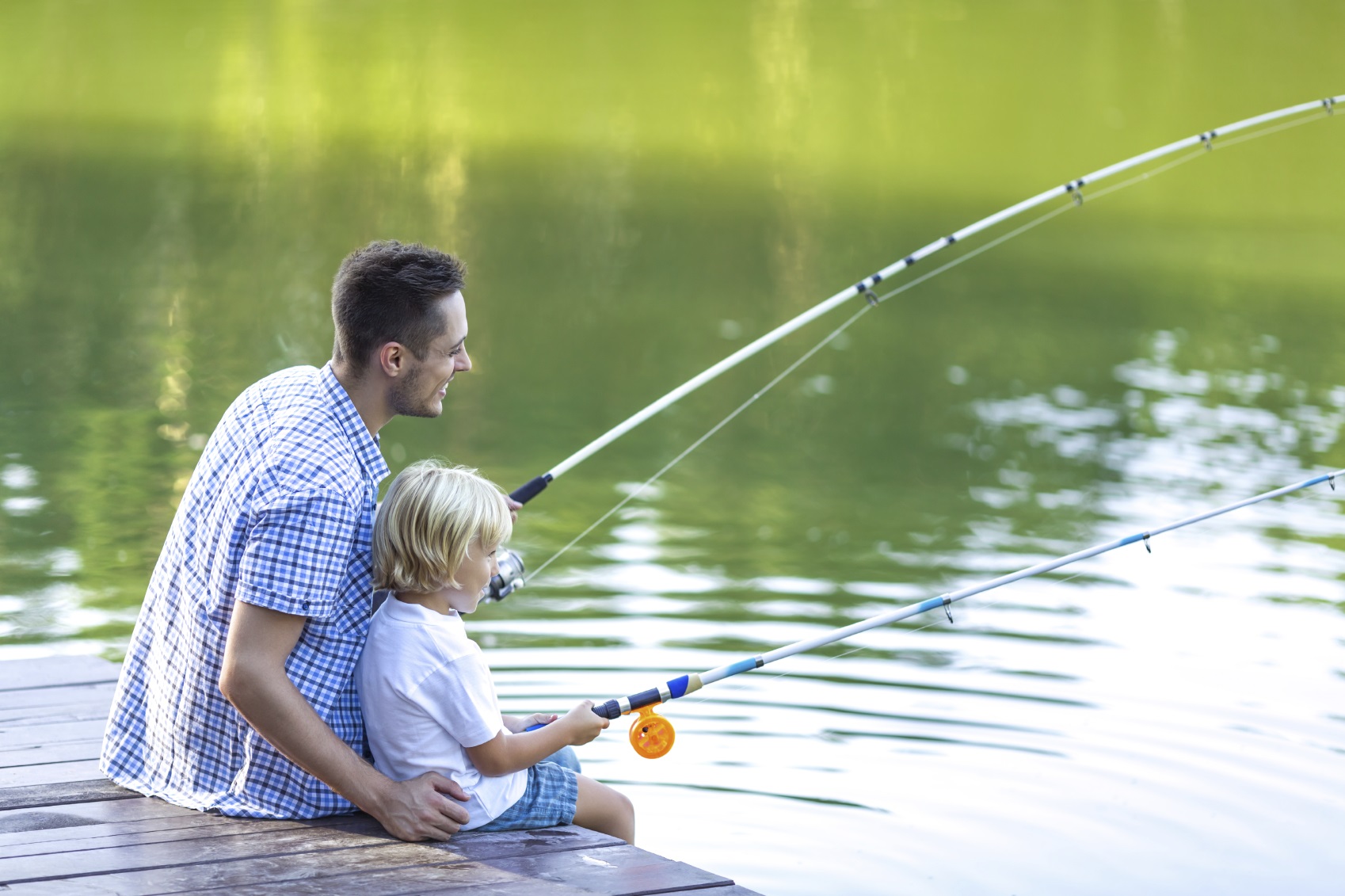 Dad and son fishing outdoors