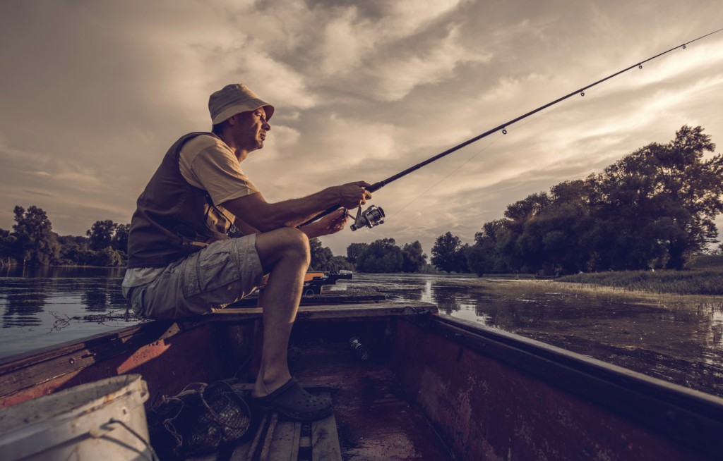 Fisherman sitting in a boat fishing.