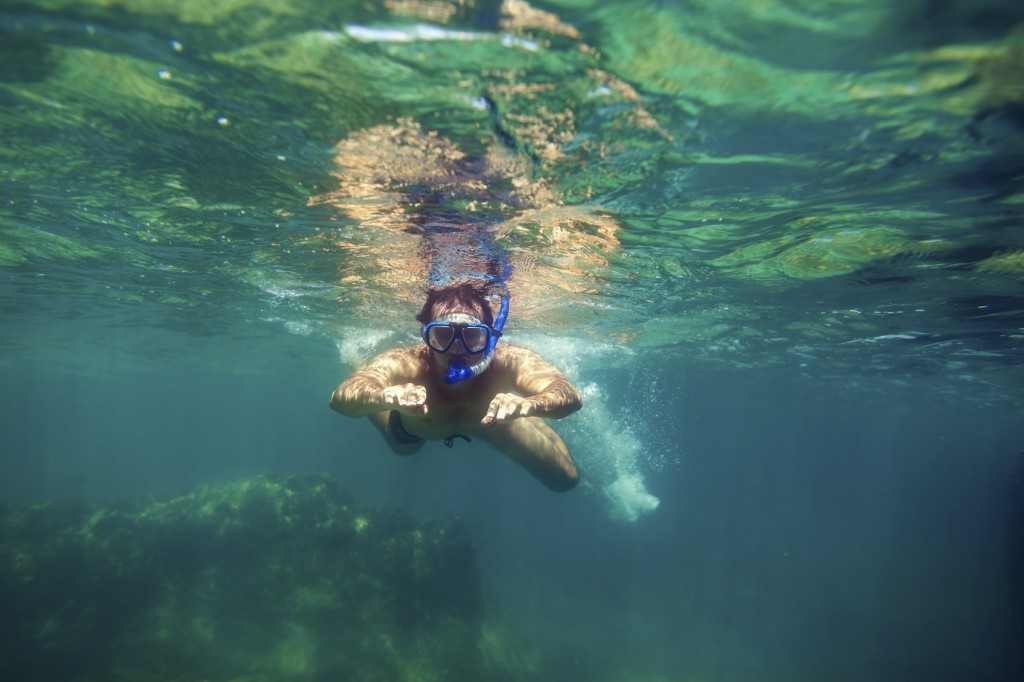 snorkling man swim underwater in turquoise sea